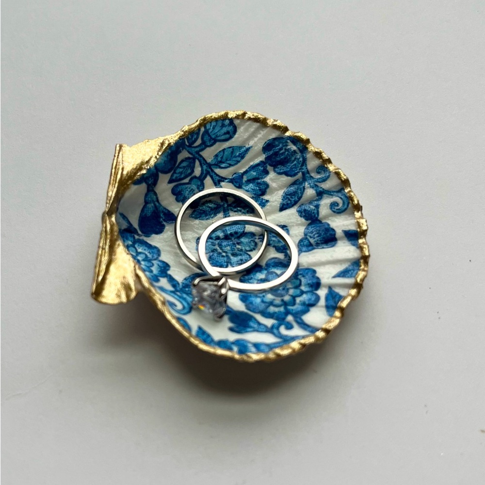 Small handmade shell ring dish. Blue flower print inside, with a gold trim.
